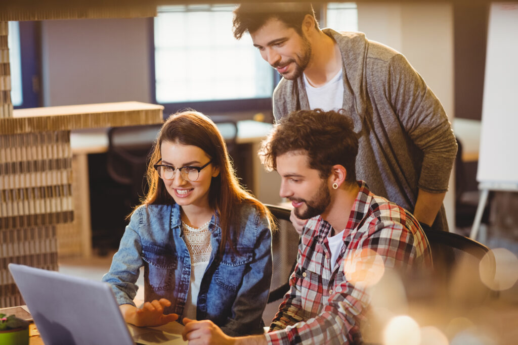 How Much Does It Cost to Make a Landing Page? 3 graphic-designer-using-laptop-with-his-coworker