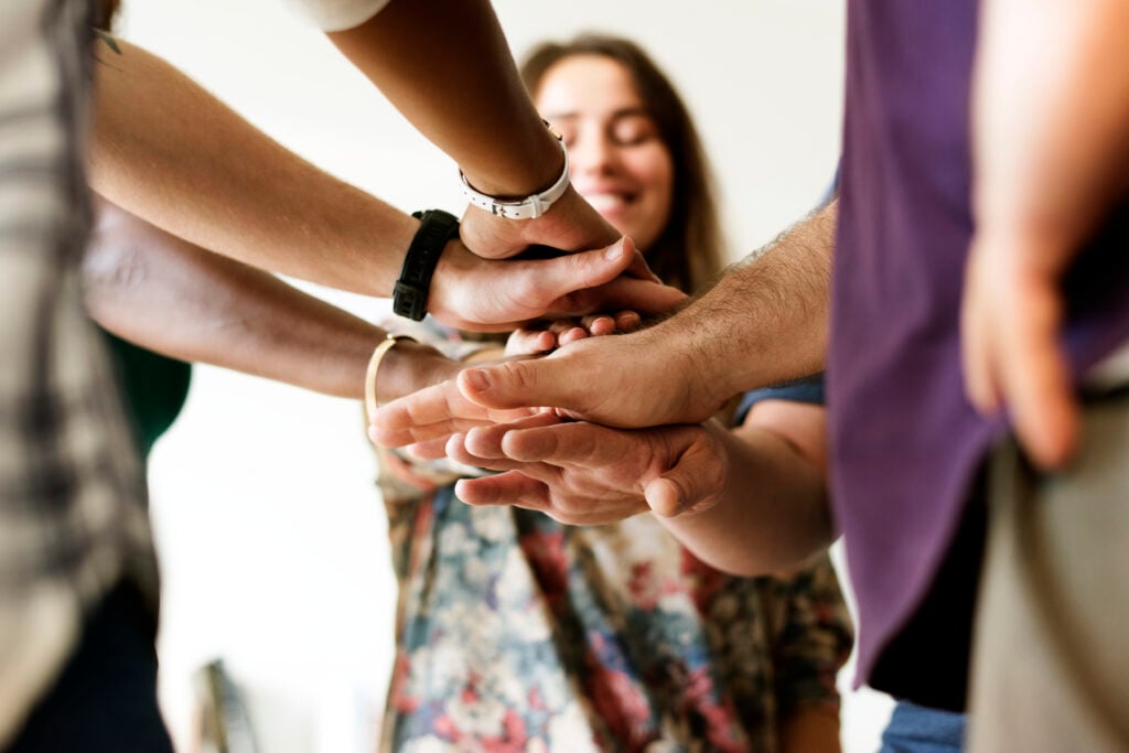 WordPress vs Sitefinity: Which CMS Is Better for You 12 group-diverse-people-joined-hands-together-teamwork