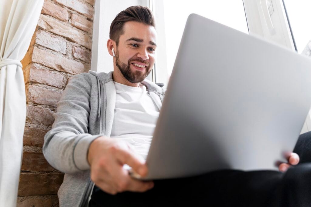 How Much Does It Cost to Make a Landing Page? 8 man-home-having-videocall-with-family