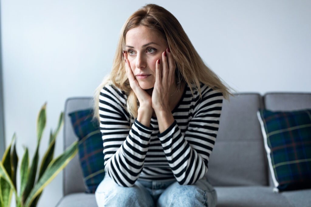 How Much Does It Cost to Make a Landing Page? 4 shot-depressed-young-woman-thinking-about-her-problems-while-sitting-sofa-home
