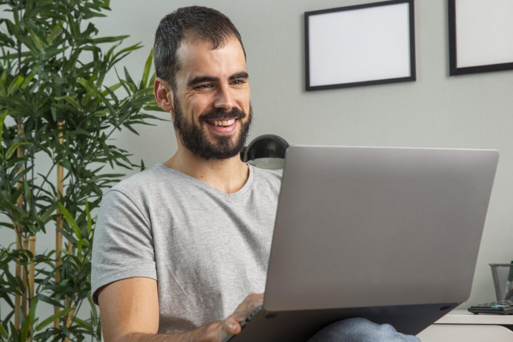 smiley-man-working-from-home-laptop