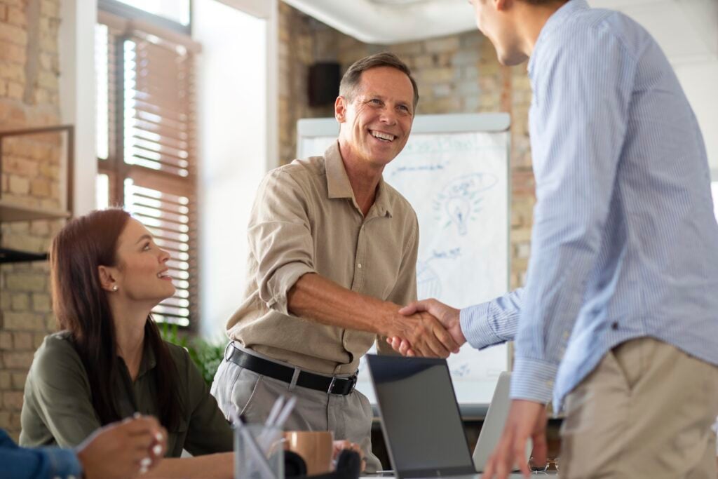 Hiring a Website Redesign Agency: A Simple Guide 3 close-up-smiling-person-conference-room