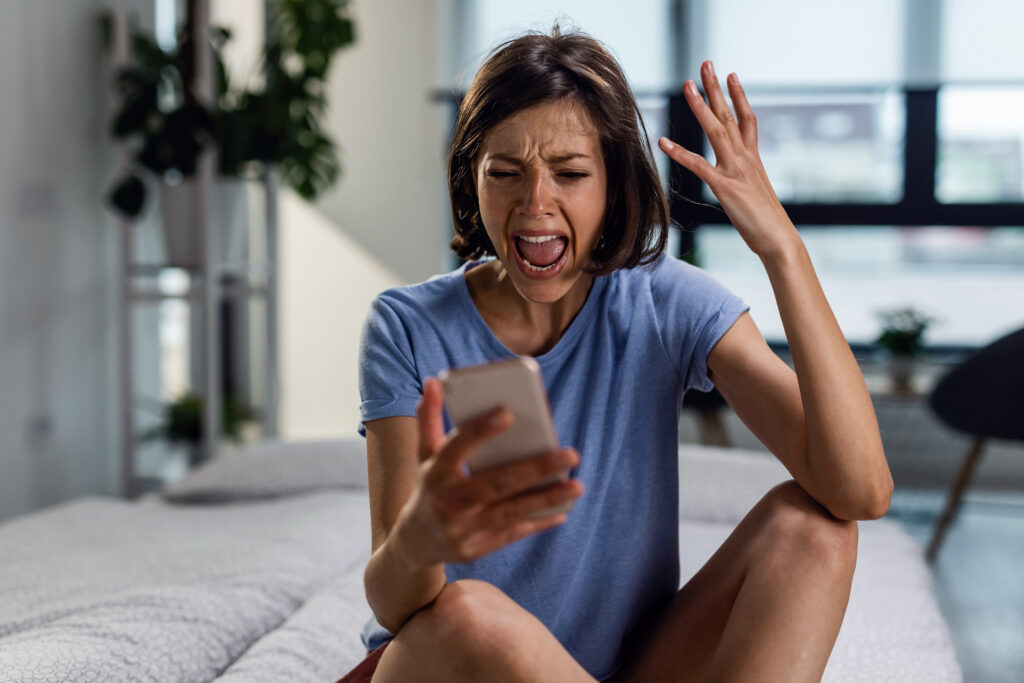 What is Responsive Design, and Why is it Important? (Full Guide) 2 Angry woman screaming while reading text message on her phone.
