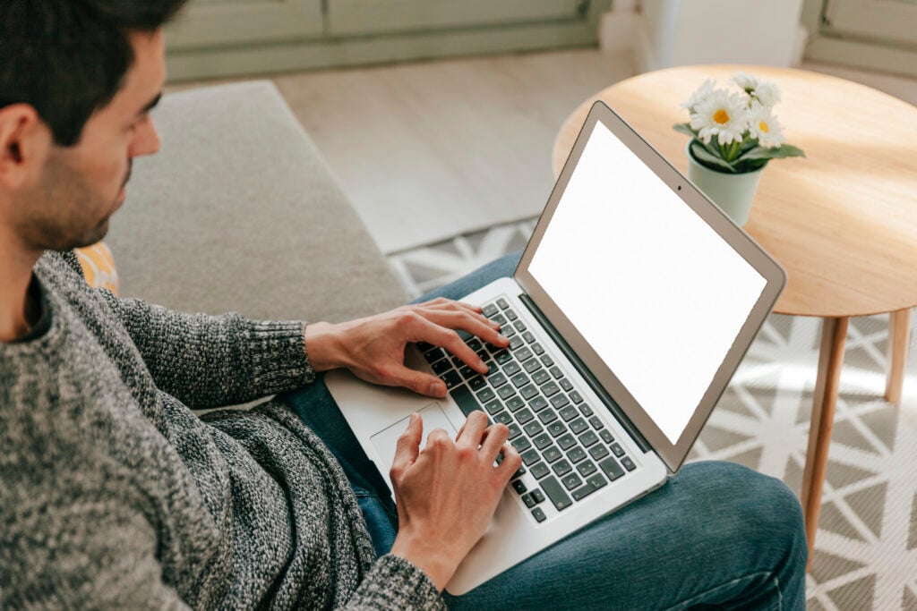man-using-laptop-sofa