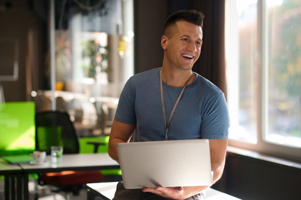 Young man sitting on the table with a laptop