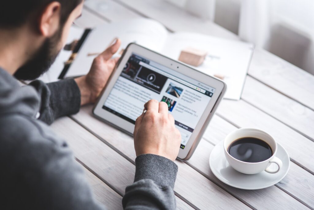 Website Maintenance Cost: How Much Should You Budget? 4 worker-reading-news-with-tablet