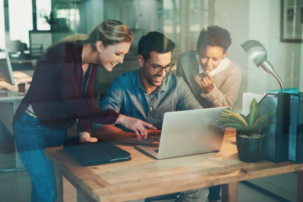 How Much Does it Cost to Hire a Website Designer? (for Agencies) 2 graphic-designer-office-presentation-meeting-discussion-teamwork-with-laptop-creative-businesspeople-partnership-collaboration-small-business-internet-startup-planning