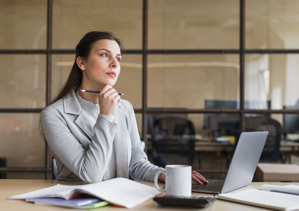 contemplating-businesswoman-sitting-front-laptop-office